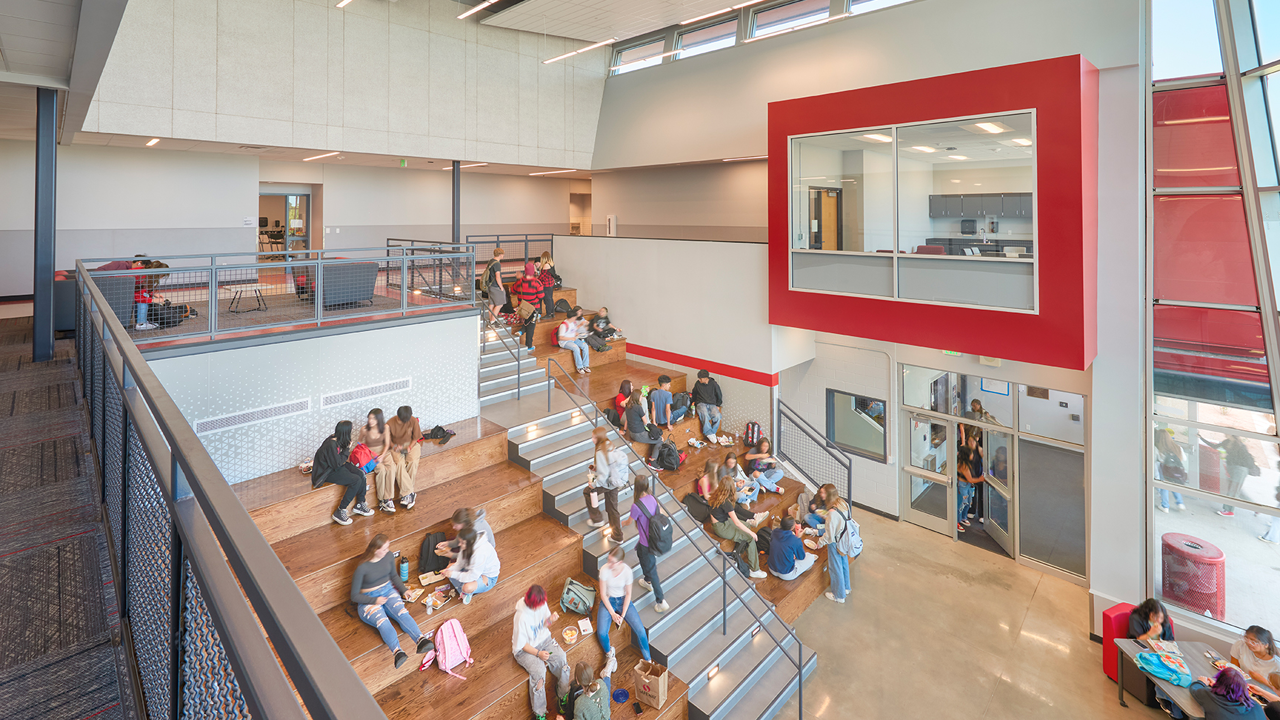 Brighton HS lobby with students sitting on stairs