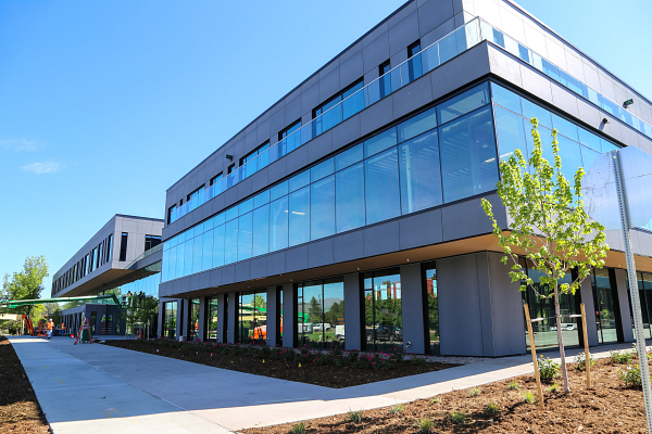 Main entry plaza of the 2400 Central office project featuring landscaped walkways, outdoor seating, and sustainable site design by OZ Architecture, constructed by Saunders Construction