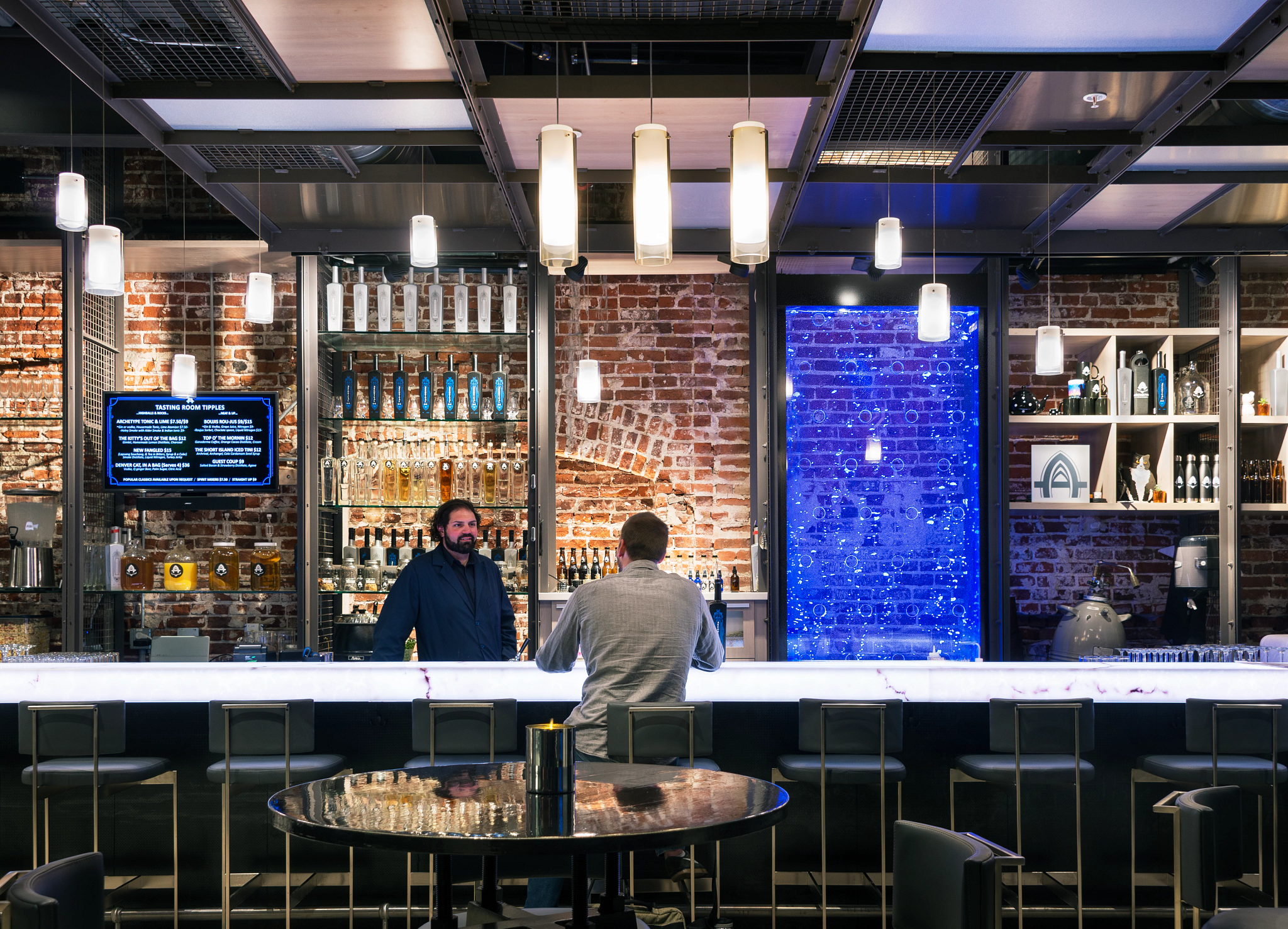 man ordering a drink at the bar at the Archetype Distillery